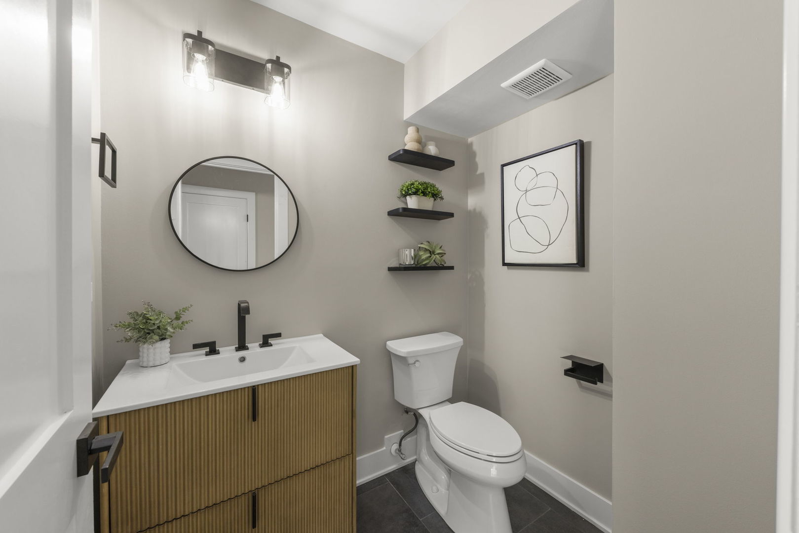 625 Edward Road Naperville, IL 60540 - Photo 19 of 47 a bathroom with a toilet a sink and mirror