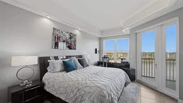 a bedroom with bed and wooden floor