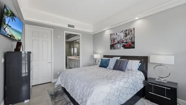 a bedroom with a bed and a painting on the wall