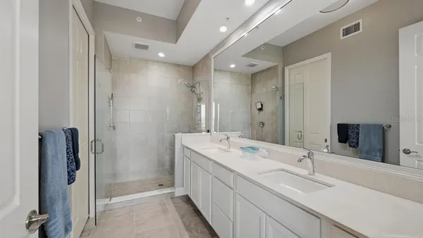 a bathroom with a double vanity sink mirror and double