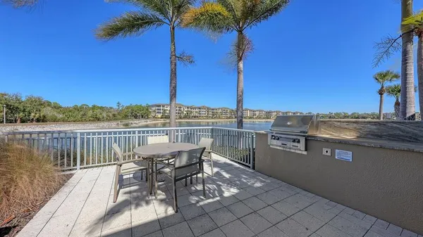 a view of a chairs and table in patio with a lake view