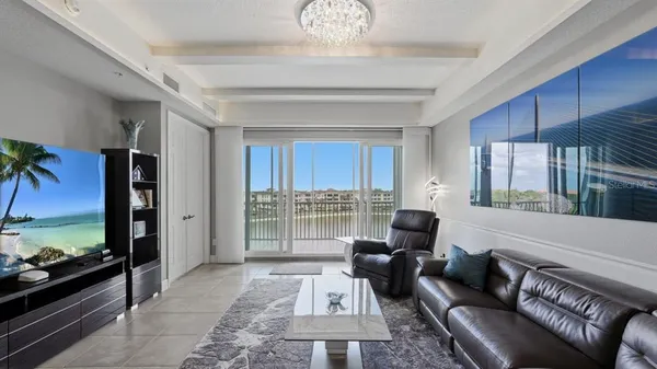 a living room with furniture tv and a large window