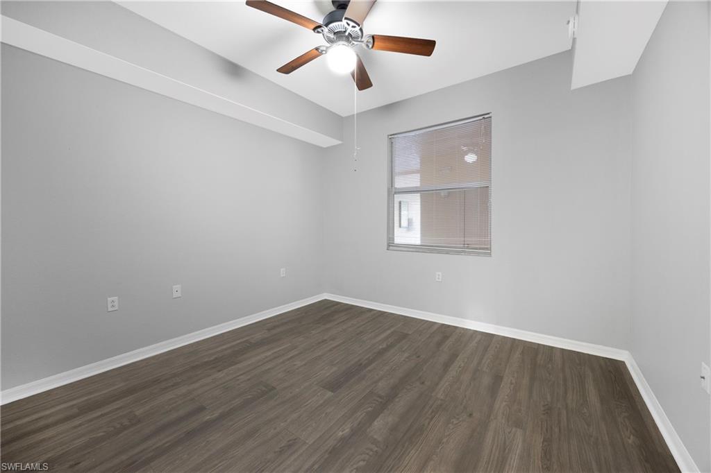 8550 Kingbird Loop, Unit 615 Estero, FL 33967 - Photo 15 of 35 wooden floor in an empty room with a window