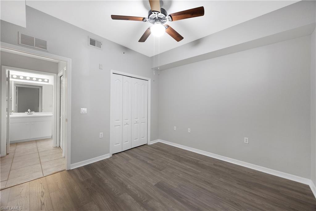 8550 Kingbird Loop, Unit 615 Estero, FL 33967 - Photo 16 of 35 wooden floor in an empty room with a bathroom