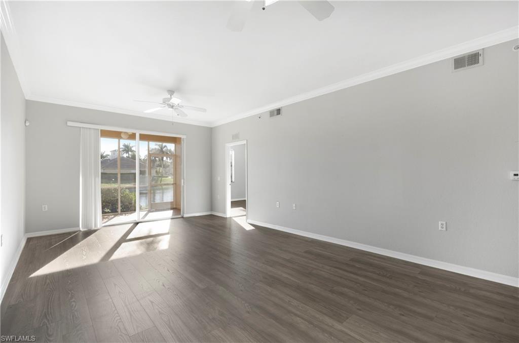 8550 Kingbird Loop, Unit 615 Estero, FL 33967 - Photo 20 of 35 a view of an empty room with wooden floor and a window