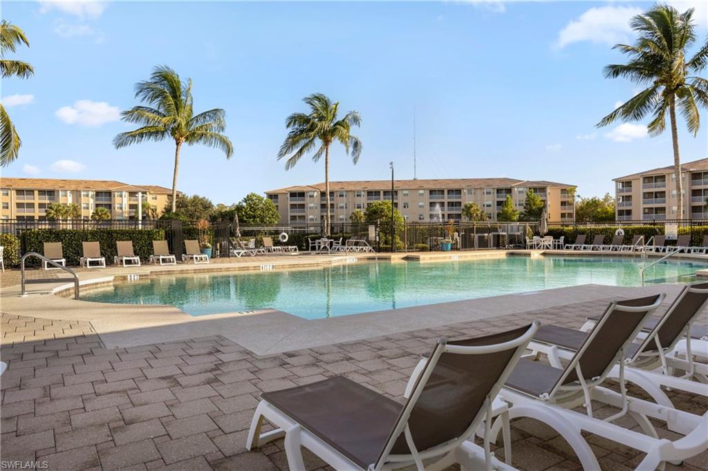 8550 Kingbird Loop, Unit 615 Estero, FL 33967 - Photo 2 of 35 a view of a lake with a table and chairs