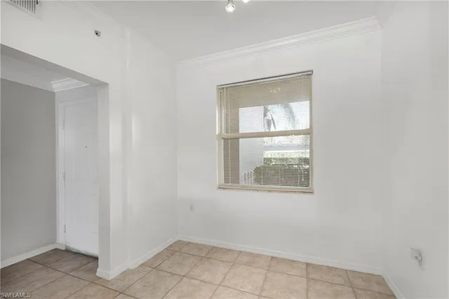 a room with walk in closet and empty shelves