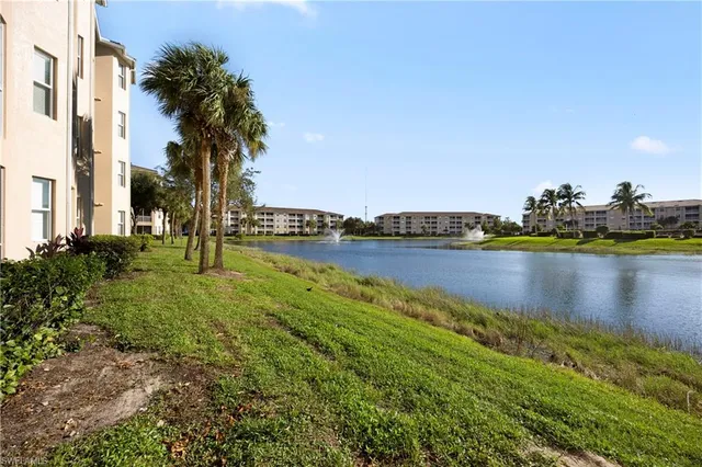 a view of a lake with houses in the back