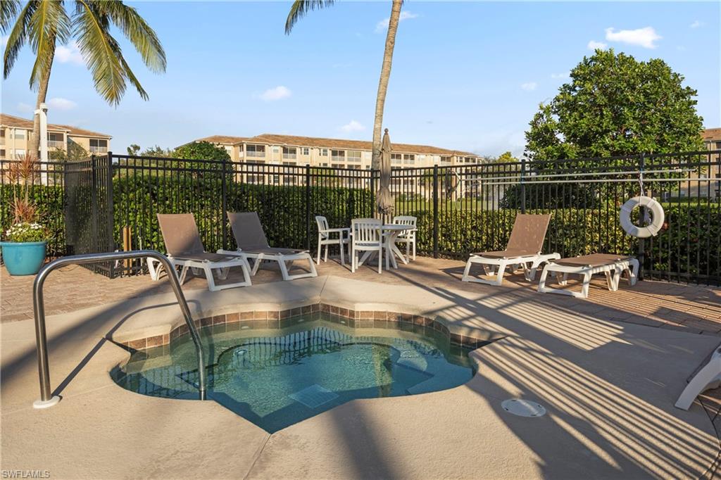 8550 Kingbird Loop, Unit 615 Estero, FL 33967 - Photo 30 of 35 a view of a swimming pool with a lounge chair