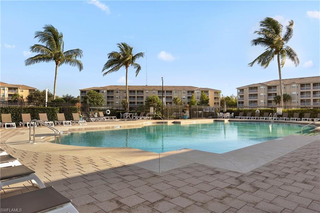 8550 Kingbird Loop, Unit 615 Estero, FL 33967 - Photo 3 of 35 a view of a swimming pool and a yard