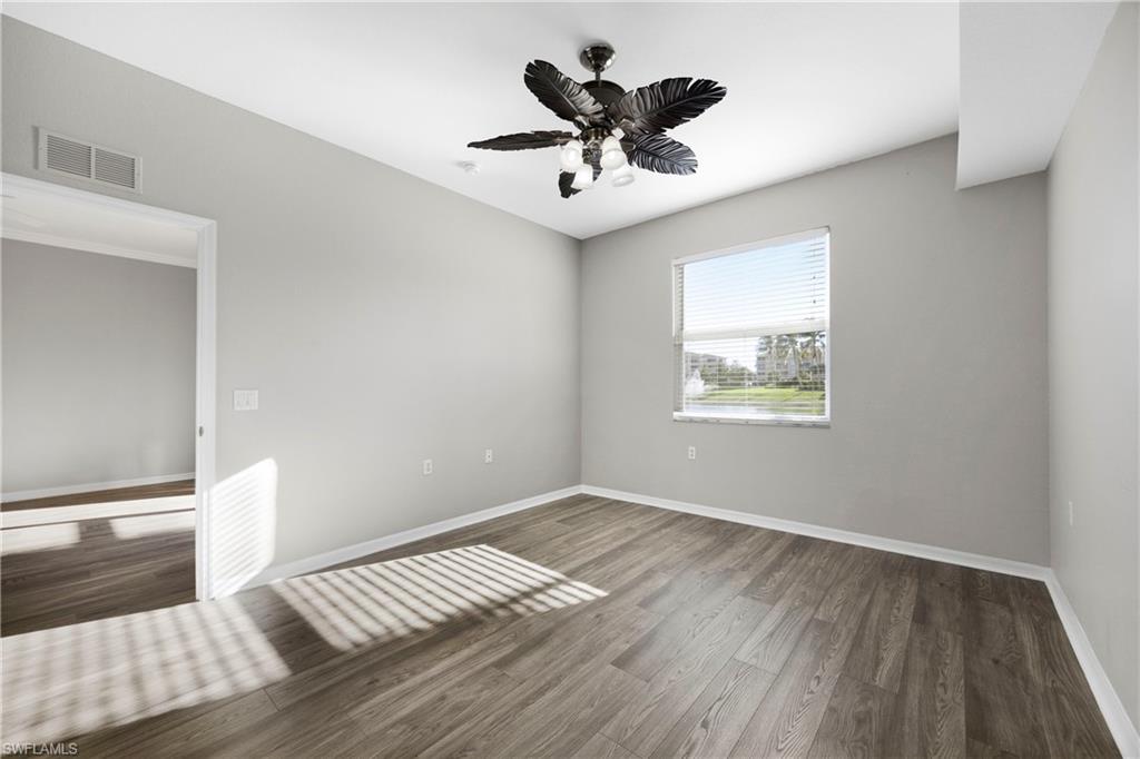 8550 Kingbird Loop, Unit 615 Estero, FL 33967 - Photo 7 of 35 a view of an empty room and wooden floor