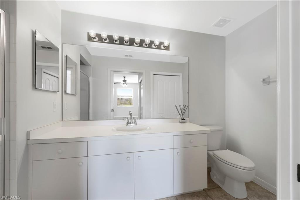 8550 Kingbird Loop, Unit 615 Estero, FL 33967 - Photo 8 of 35 a bathroom with a sink a toilet and mirror