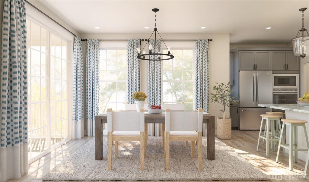 728 Station Road, Unit 524 Dunellen, NJ 08812 - Photo 5 of 11 a dining room with furniture a chandelier and wooden floor