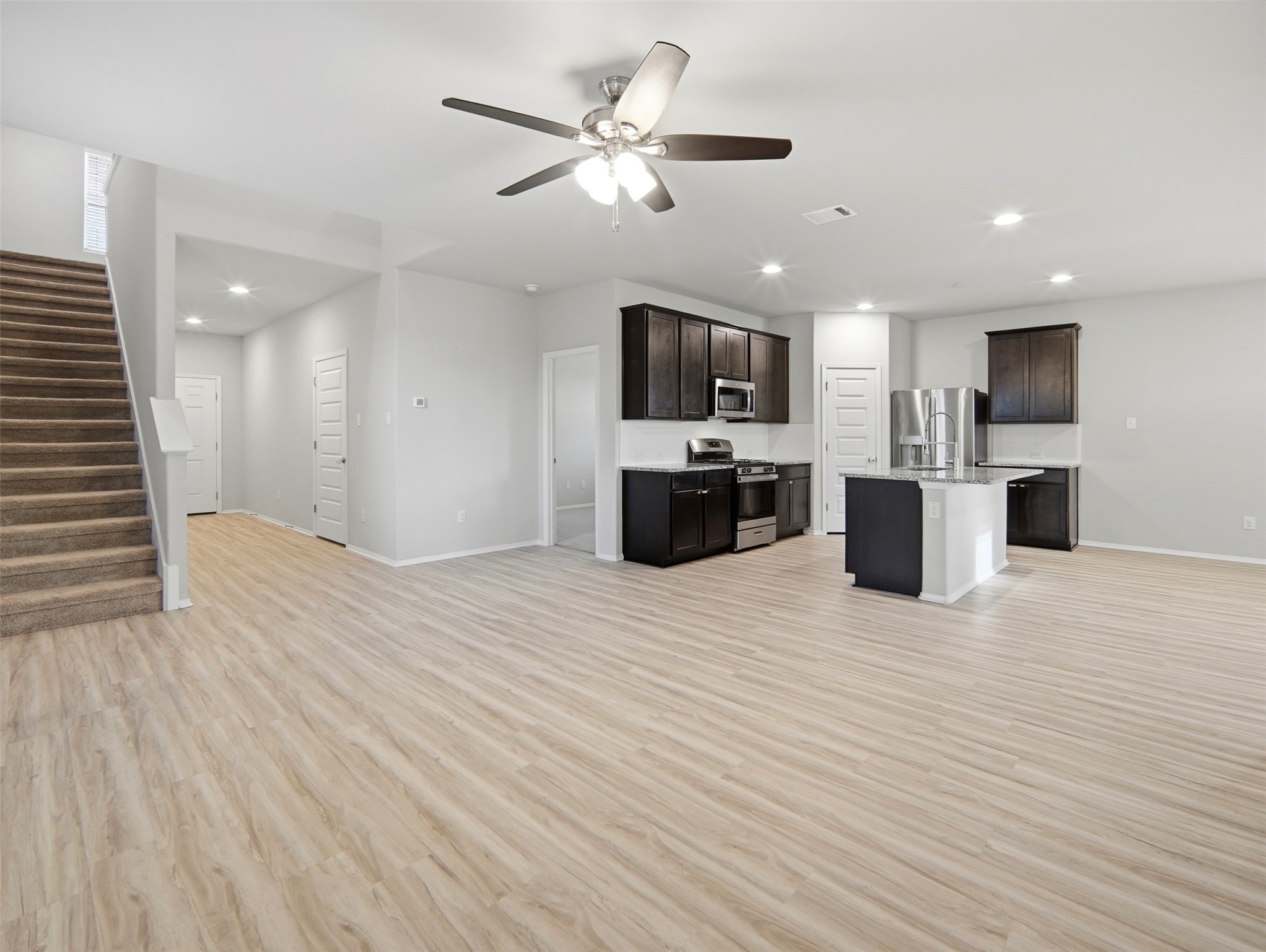 60 Bent Trl Lane Georgetown, TX 78628 - Photo 39 of 40 An open floorplan merges a well-appointed kitchen with an inviting living space, creating a seamless flow.