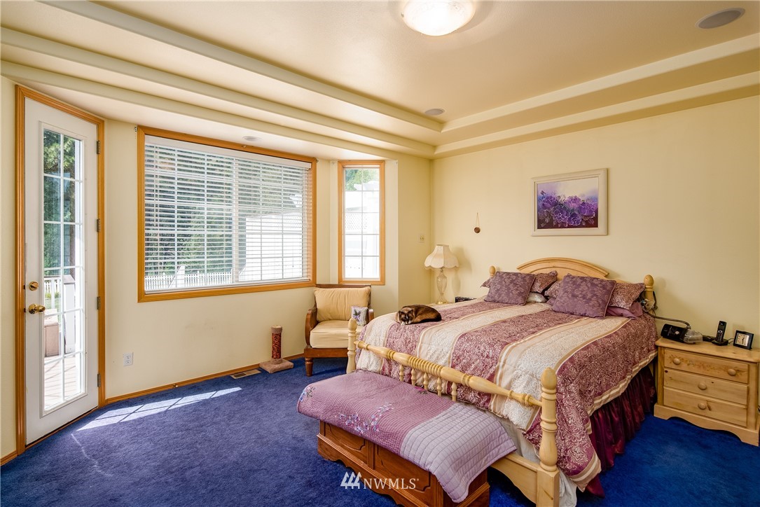 657 Williams Lake Road, Unit F Colville, WA 99114 - Photo 14 of 38 a bedroom with a bed and wooden floor