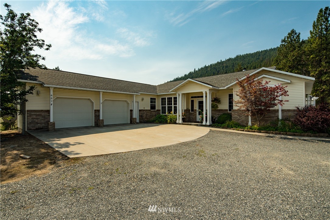 657 Williams Lake Road, Unit F Colville, WA 99114 - Photo 3 of 38 a front view of a house with a yard and garage