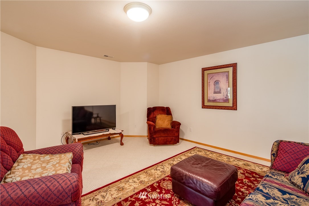 657 Williams Lake Road, Unit F Colville, WA 99114 - Photo 22 of 38 a living room with furniture and a flat screen tv