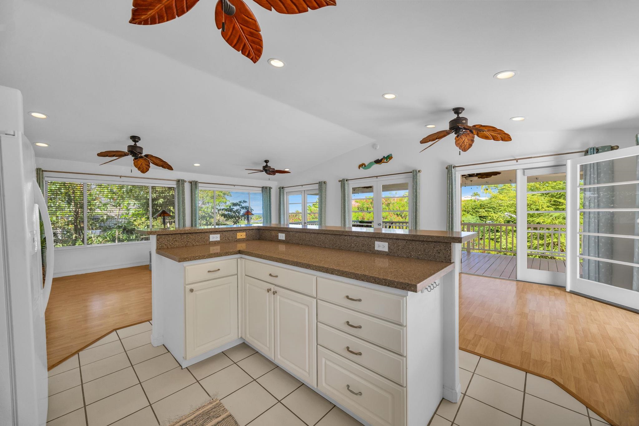 235 Keonekai Road Kihei, HI 96753 - Photo 16 of 50 a kitchen with granite countertop a stove and a sink