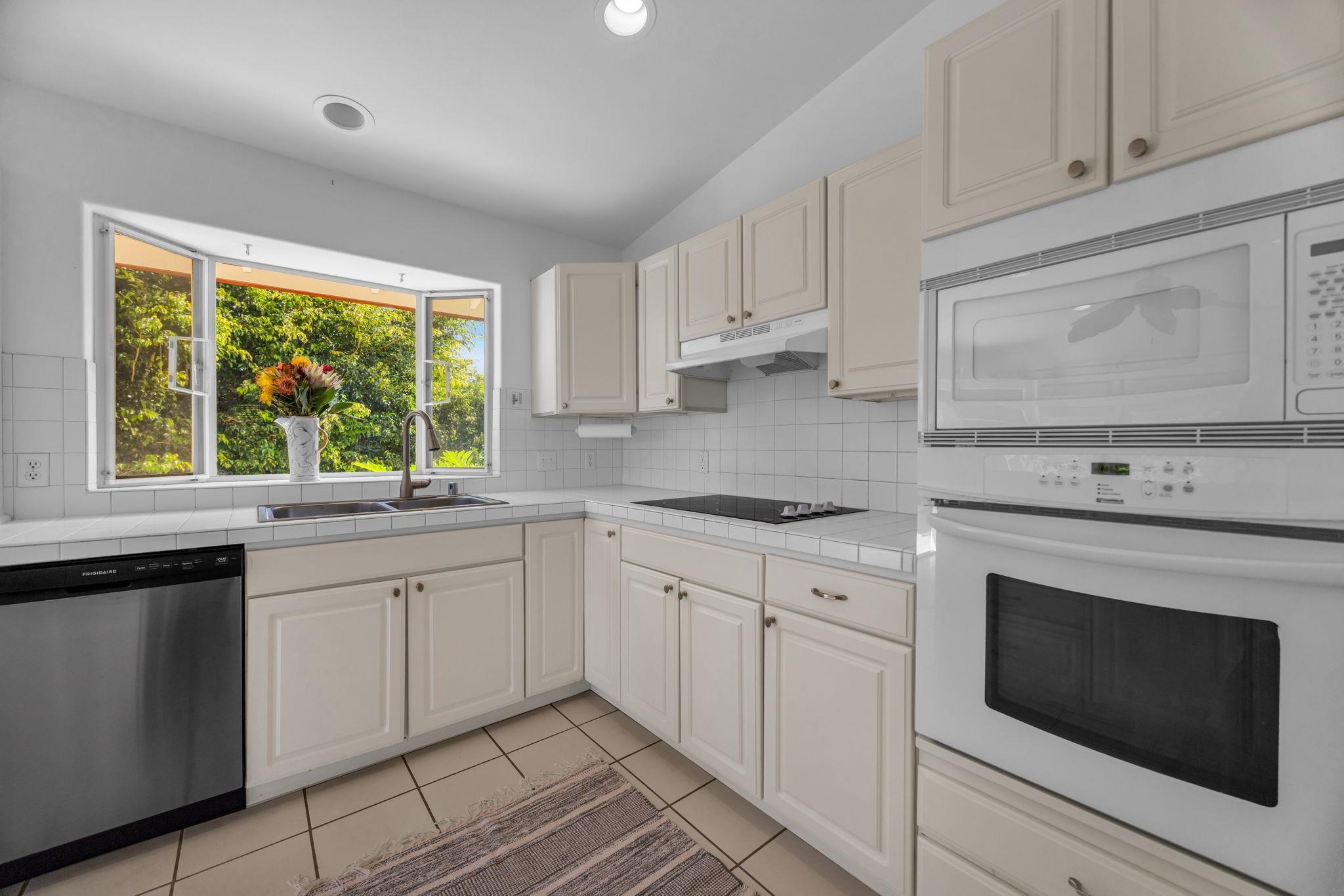 235 Keonekai Road Kihei, HI 96753 - Photo 17 of 50 a kitchen with white cabinets appliances and a window