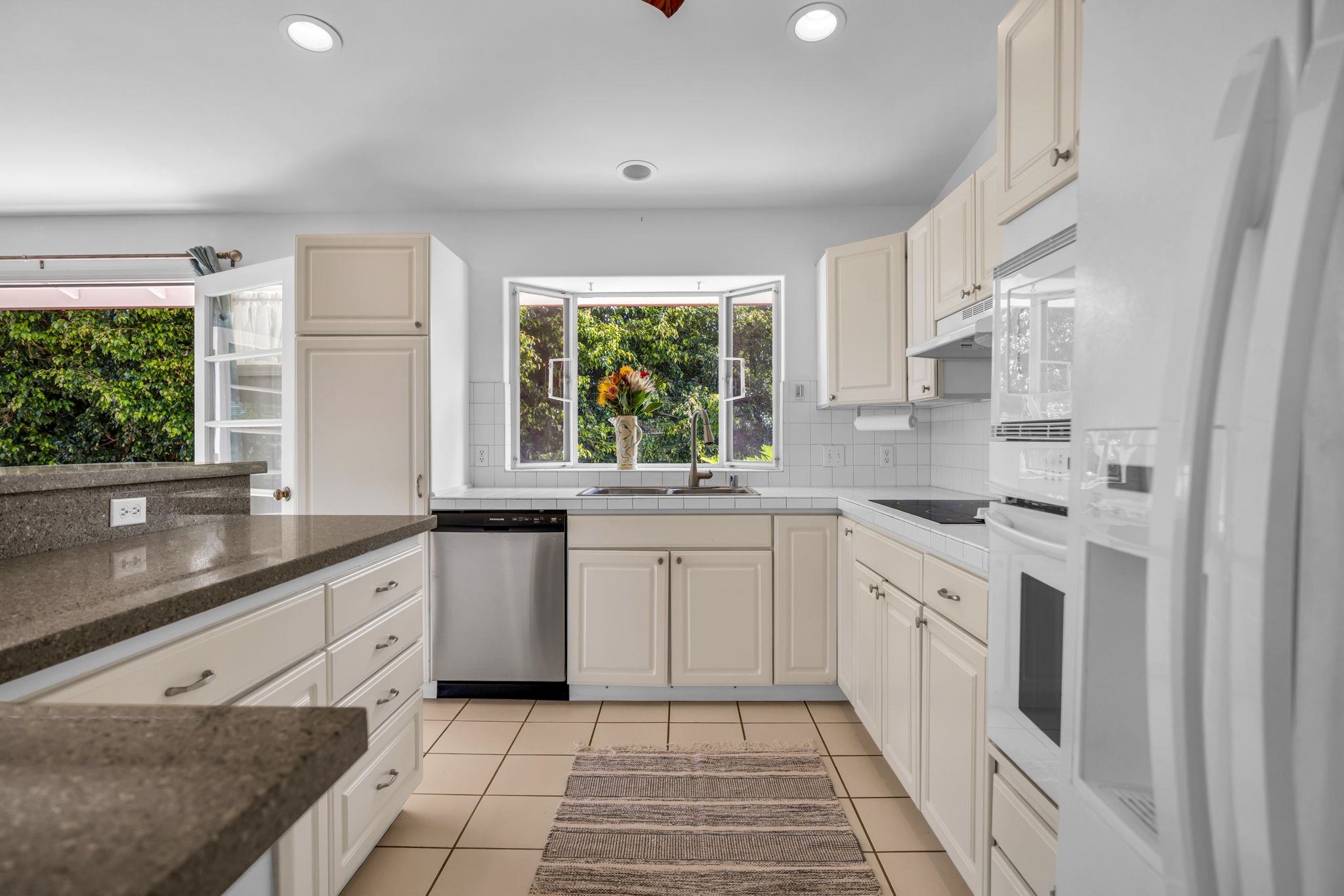 235 Keonekai Road Kihei, HI 96753 - Photo 18 of 50 a kitchen with a sink stove and cabinets