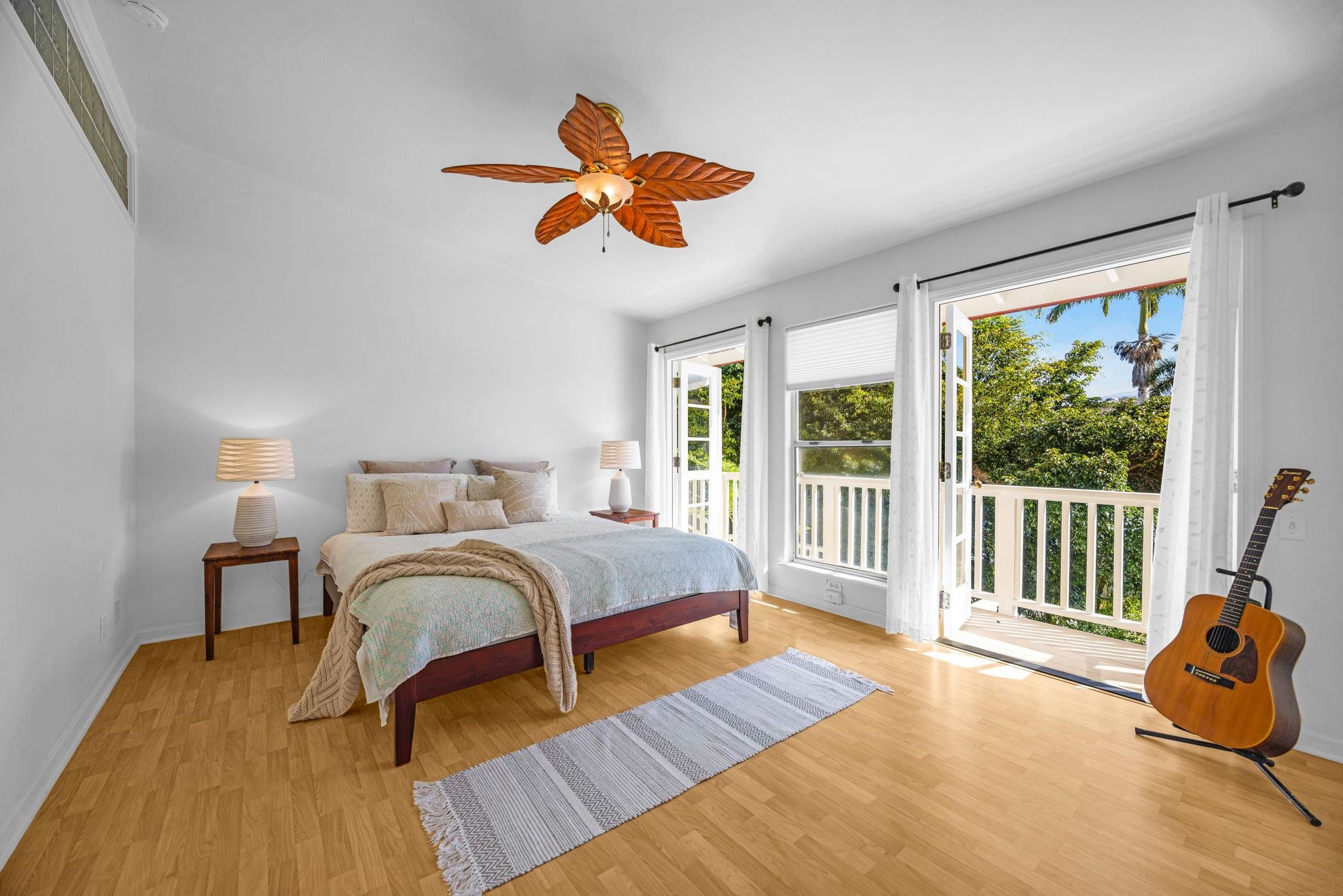 235 Keonekai Road Kihei, HI 96753 - Photo 22 of 50 a bedroom with a bed and a large window