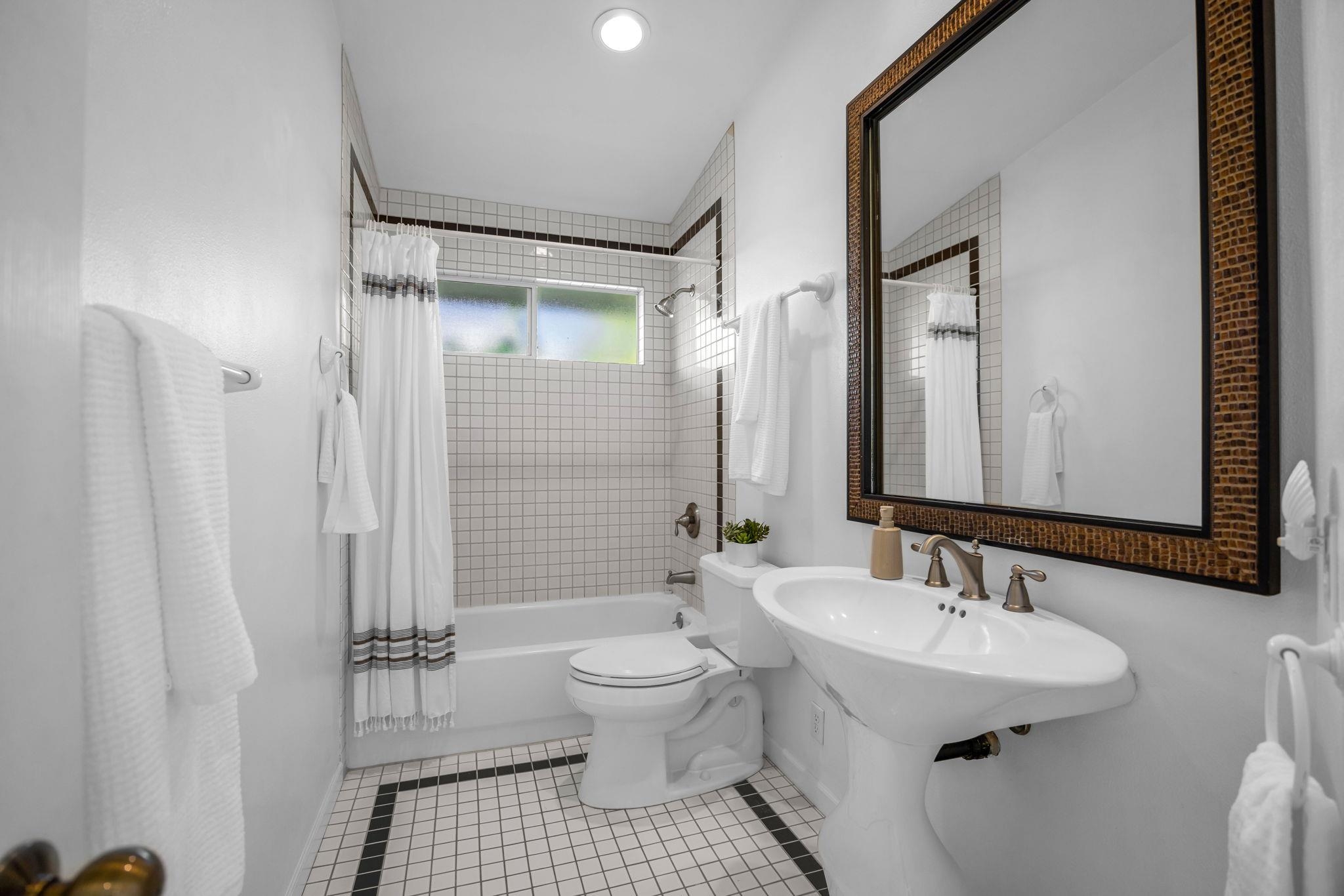 235 Keonekai Road Kihei, HI 96753 - Photo 32 of 50 a bathroom with a sink a toilet and shower