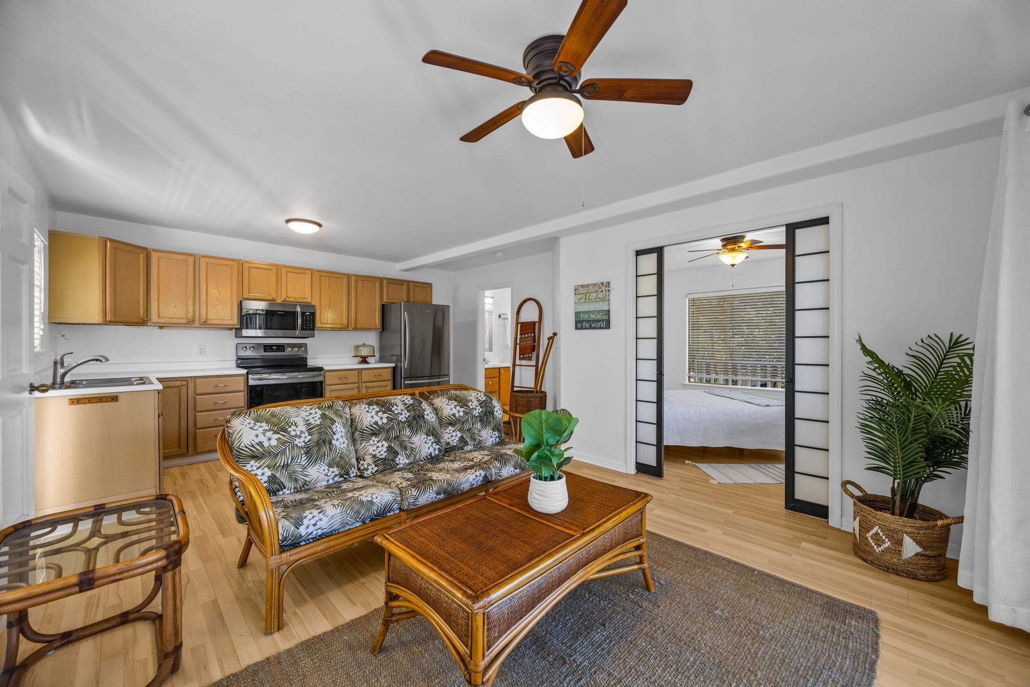 235 Keonekai Road Kihei, HI 96753 - Photo 35 of 50 a living room with furniture and a flat screen tv