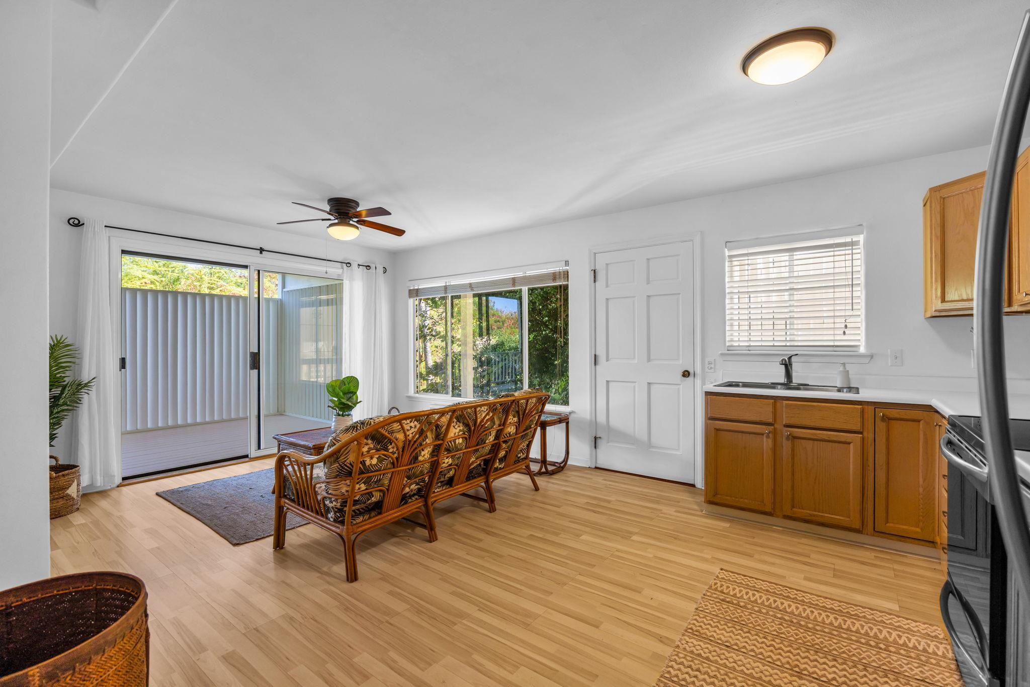 235 Keonekai Road Kihei, HI 96753 - Photo 38 of 50 a living room with furniture and a wooden floor