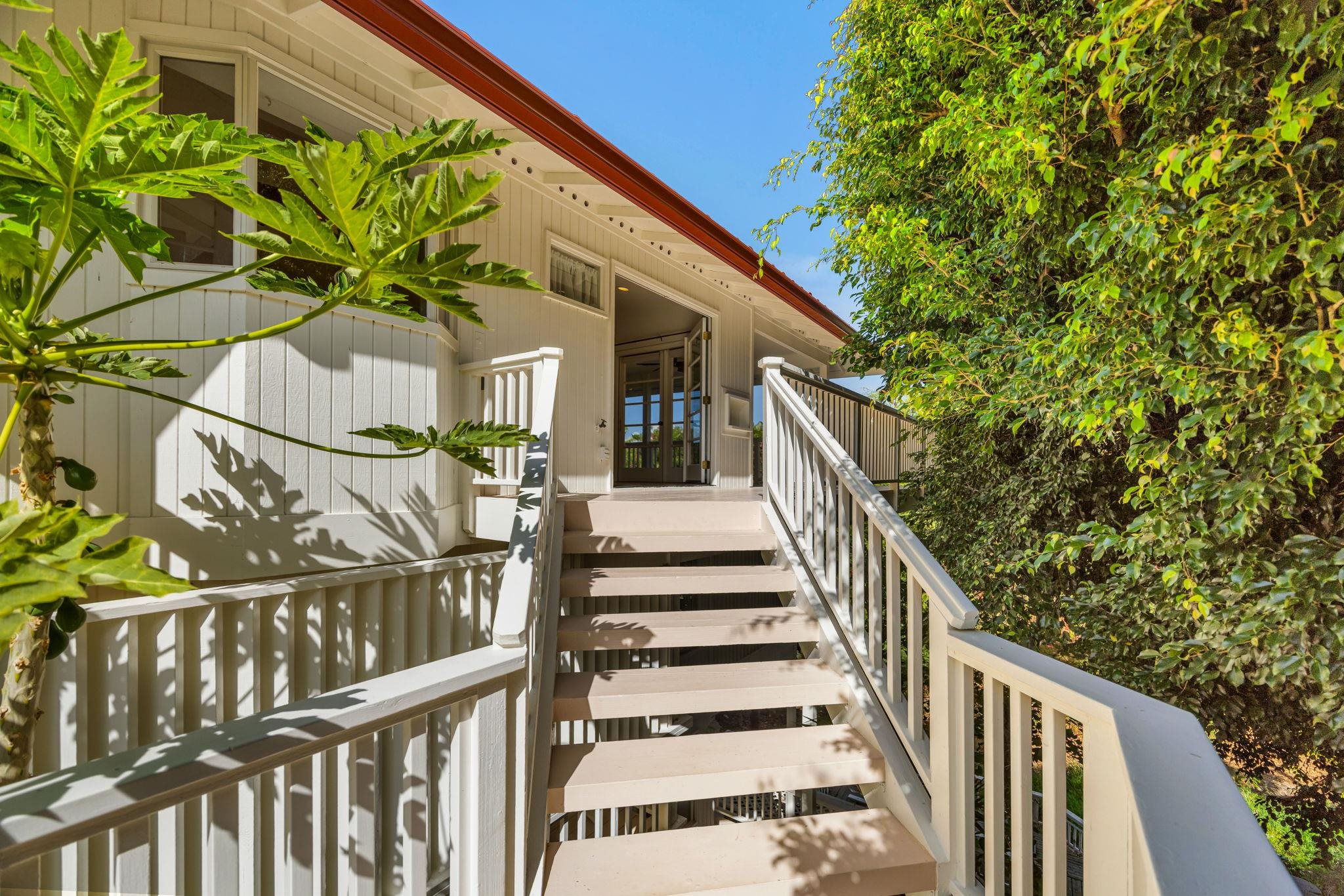 235 Keonekai Road Kihei, HI 96753 - Photo 6 of 50 a view of a house with wooden fence and two flower in a garden