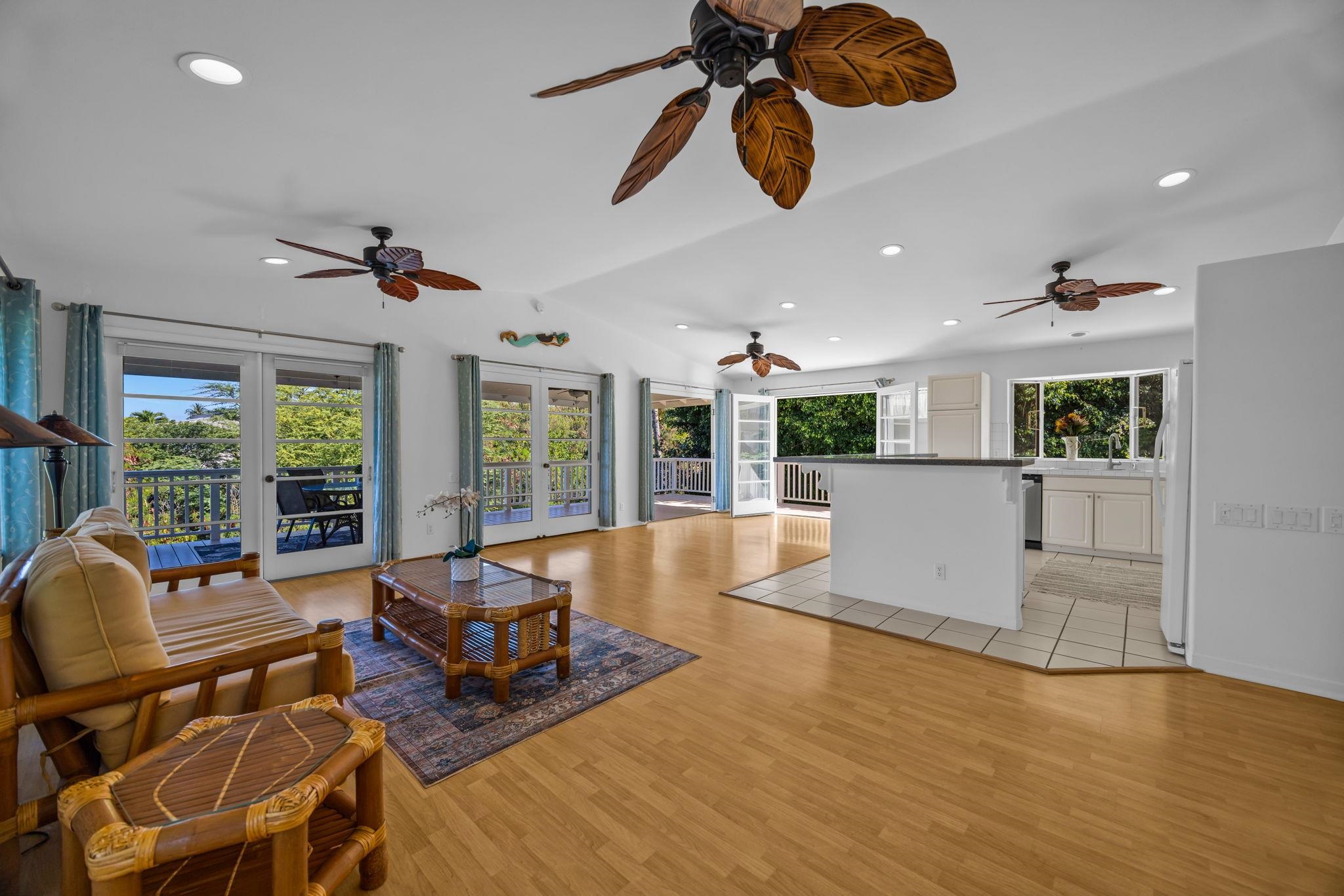 235 Keonekai Road Kihei, HI 96753 - Photo 8 of 50 a living room with fireplace furniture and a large window