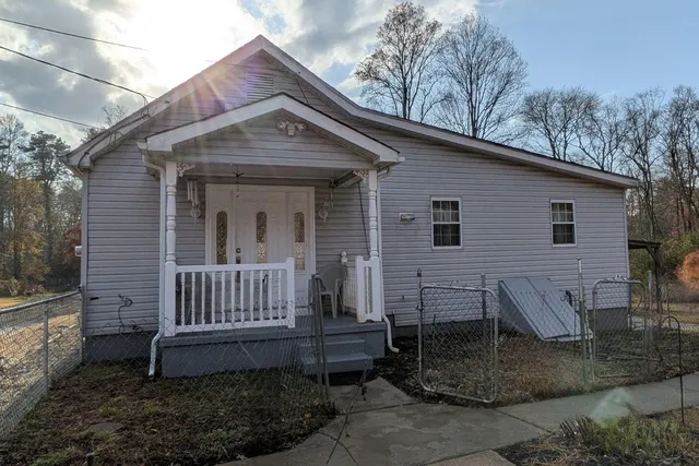 a view of a house with a yard and wooden floor