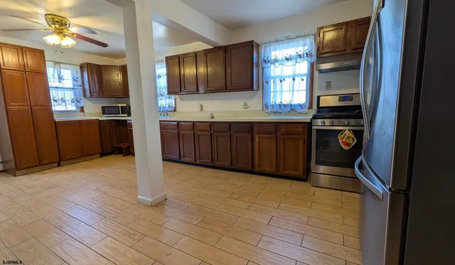 a kitchen with granite countertop stainless steel appliances and wooden cabinets