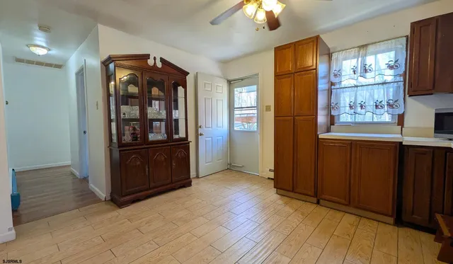an empty room with windows and cabinet