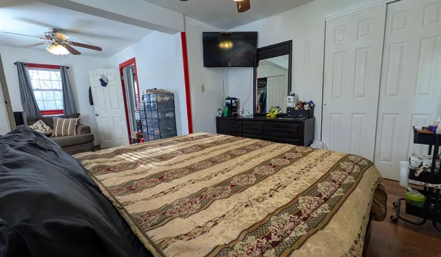 a bedroom with a bed and a dresser in it