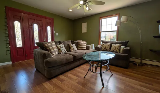 a living room with furniture and wooden floor