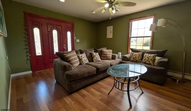 a living room with furniture and a chandelier