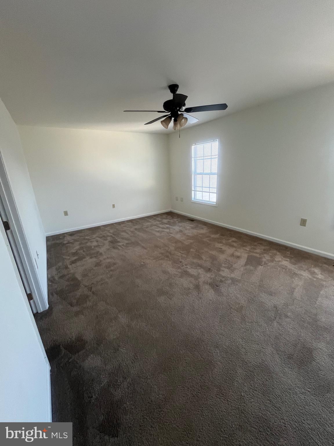 50 Fuzzy Tail Drive Ranson, WV 25438 - Photo 15 of 24 en empty room with windows and fan