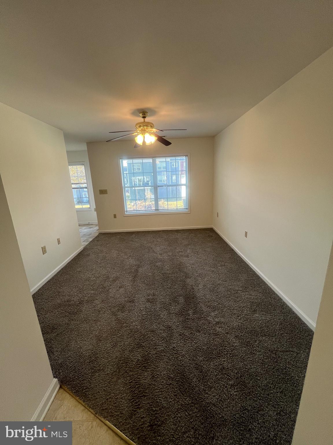 50 Fuzzy Tail Drive Ranson, WV 25438 - Photo 3 of 24 en empty room with windows and chandelier fan