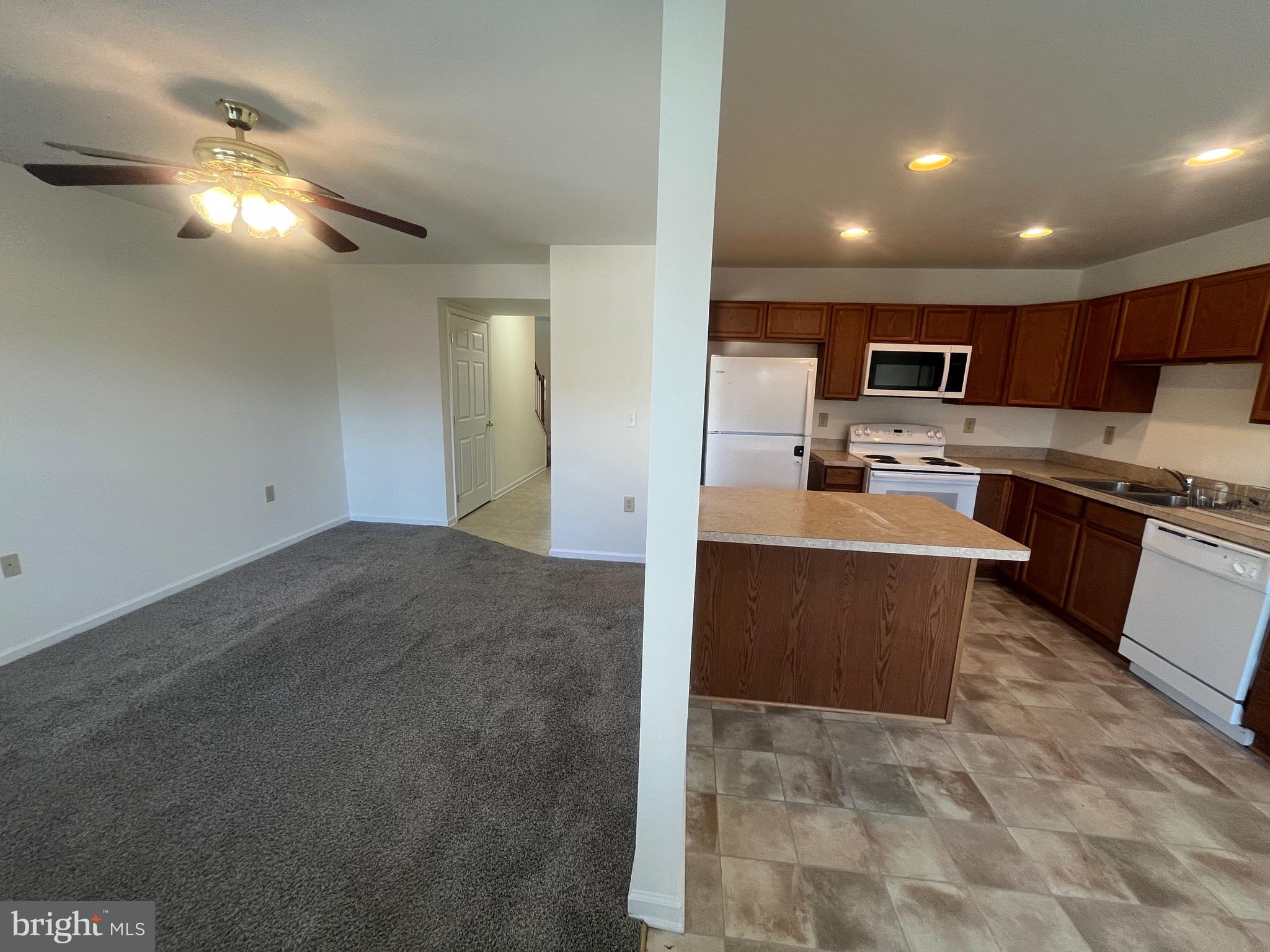 50 Fuzzy Tail Drive Ranson, WV 25438 - Photo 8 of 24 a large kitchen with cabinets and stainless steel appliances