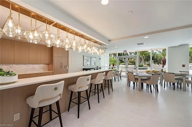 a dining hall with furniture and a large window