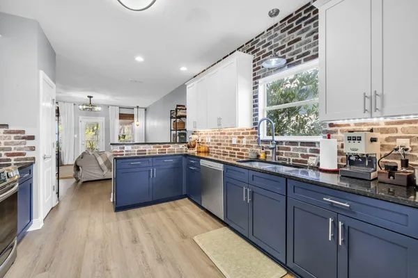 a large kitchen with a large window and counter space