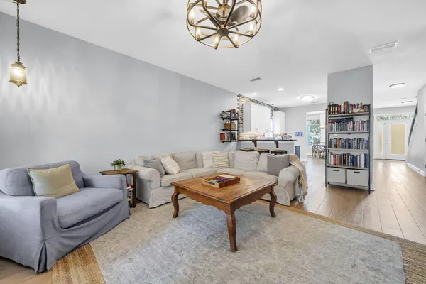a living room with furniture and a book shelf