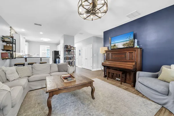 a living room with furniture and a wooden floor