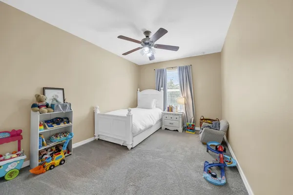 a bedroom with furniture and a window
