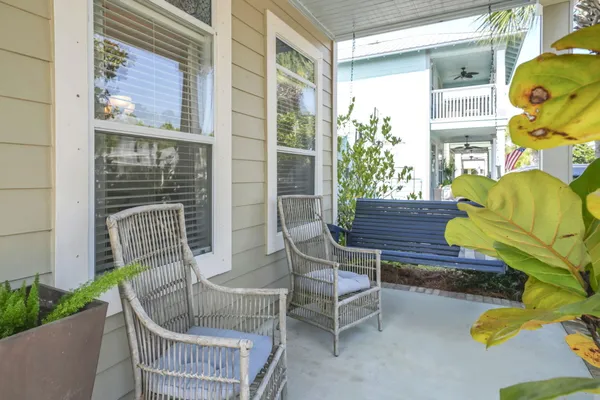 a balcony with furniture and a potted plant