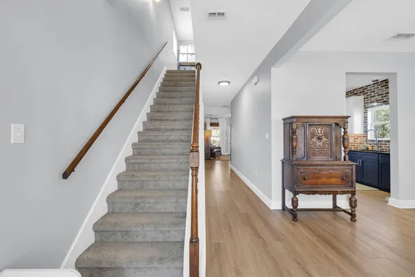 a view of entryway and hall with wooden floor