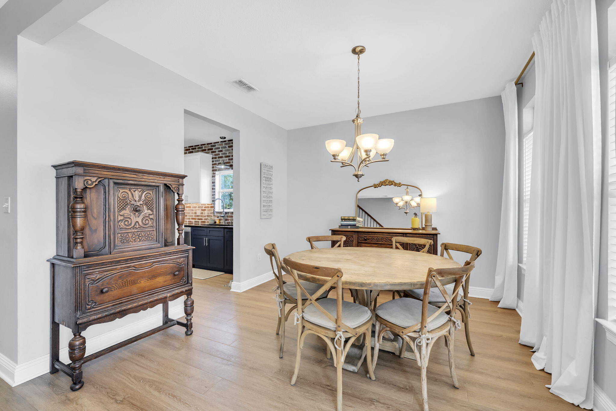 98 Bald Eagle Drive Santa Rosa Beach, FL 32459 - Photo 10 of 48 a dining room with wooden floor a chandelier a wooden table and chairs