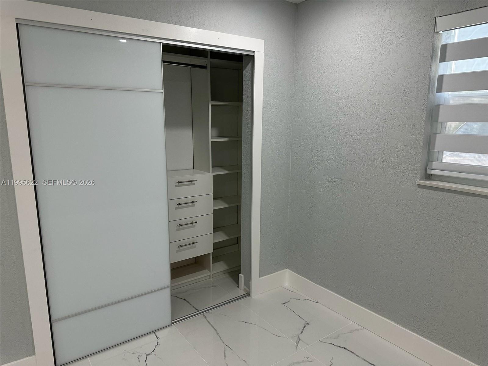 10745 Southwest 222nd Street, Unit 10745 Miami, FL 33170 - Photo 11 of 26 a view of an empty walk in closet