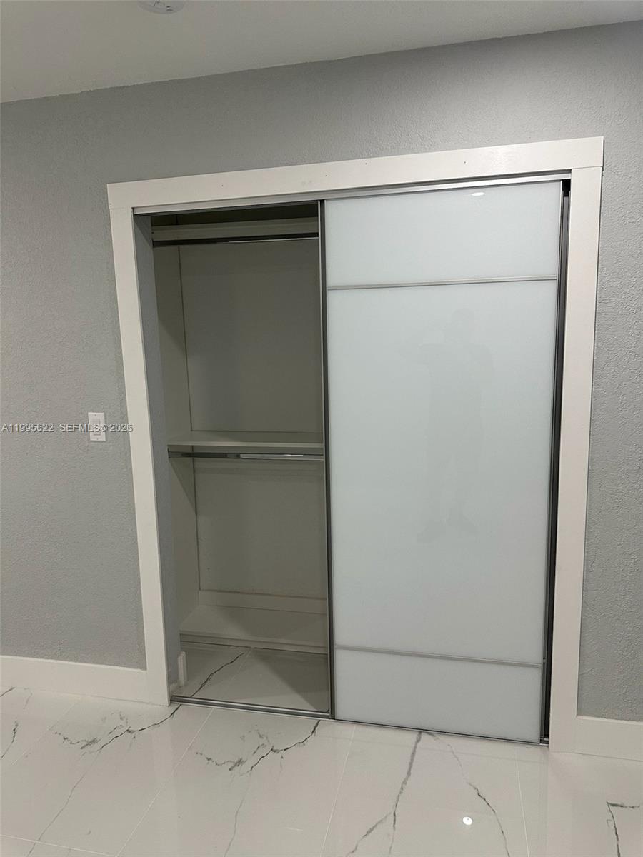 10745 Southwest 222nd Street, Unit 10745 Miami, FL 33170 - Photo 14 of 26 a refrigerator freezer a stove and a glass door