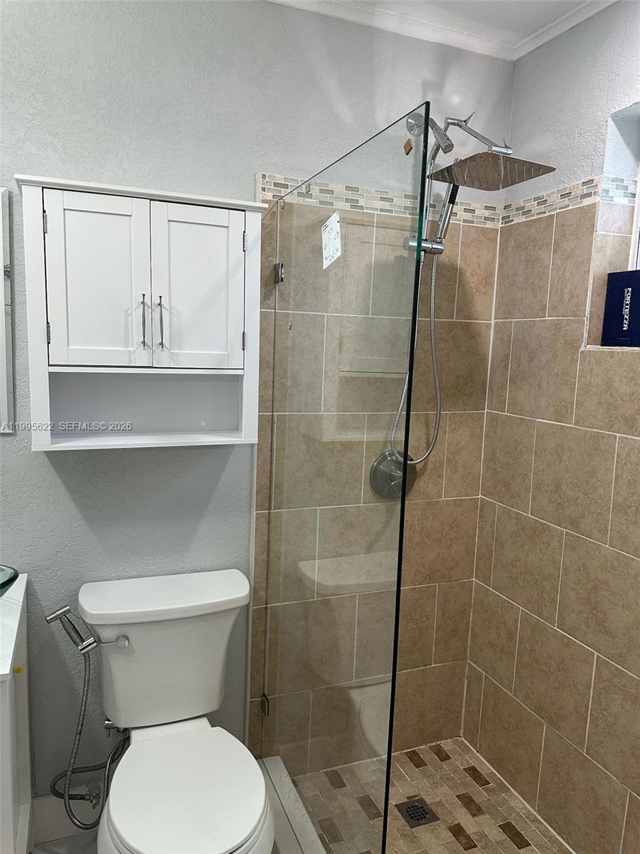 10745 Southwest 222nd Street, Unit 10745 Miami, FL 33170 - Photo 16 of 26 a bathroom with a toilet and a shower